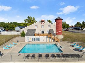 Peoria apartment for rent - A pool area with a building and a red tower.