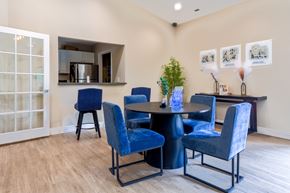 Farmington Hills apartment for rent - A dining room with blue chairs and a table.