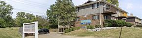 Peoria apartment for rent - A building with a sign that says Kingston Apartments.