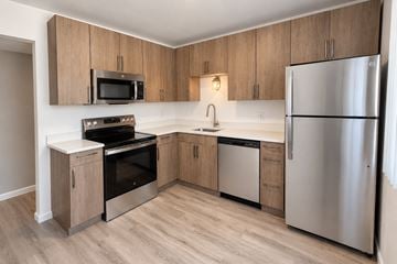 Waterford Township apartment for rent - A kitchen with wooden cabinets and stainless steel appliances.