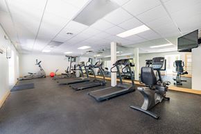 Grand Blanc apartment for rent - A gym with treadmills, exercise bikes, and other equipment.