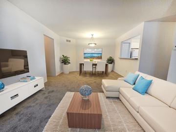 Farmington Hills apartment for rent - A living room with a white couch, a wooden coffee table, and a painting on the wall.