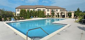 Commerce Township apartment for rent - a large swimming pool with a hotel in the background
