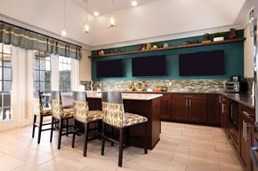 Commerce Township apartment for rent - A kitchen with a table and chairs in front of a window.