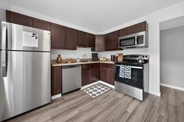 Waterford Township apartment for rent - A kitchen with a stainless steel refrigerator and microwave.
