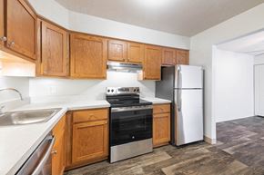 Westland apartment for rent - A kitchen with wooden cabinets and a stainless steel refrigerator.