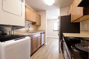 Trenton apartment for rent - A kitchen with a black stove top oven and white appliances.