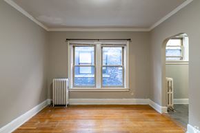 Detroit apartment for rent - A room with a window and a radiator.