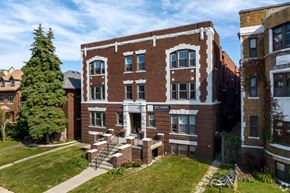 Detroit apartment for rent - A red brick building with a white sign on the front.