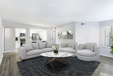 Decatur apartment for rent - A modern living room with a grey sofa set and a coffee table.