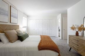 Auburn Hills apartment for rent - A bedroom with a bed, dresser, and two framed pictures on the wall.