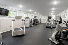 Auburn Hills apartment for rent - A gym with a variety of exercise equipment including treadmills, stationary bikes, and weight machines.