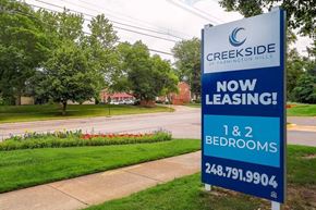 Farmington Hills apartment for rent - A sign for Creekside Farmlington Hills advertises that 1 and 2 bedroom apartments are now leasing.