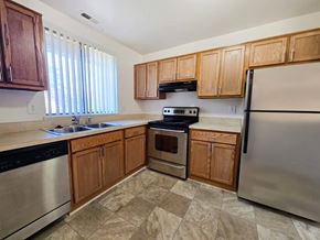 Farmington Hills apartment for rent - A kitchen with wooden cabinets and stainless steel appliances.