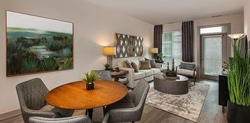 Auburn Hills apartment for rent - A living room with a wooden table and grey chairs.