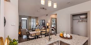 Auburn Hills apartment for rent - A kitchen with a table and chairs in the middle of the room.