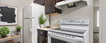 Sterling Heights apartment for rent - A white refrigerator stands next to a white oven in a kitchen.