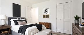 Sterling Heights apartment for rent - A bedroom with a large bed and a bench.