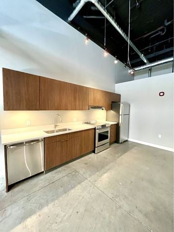 St. Louis apartment for rent - A kitchen with wooden cabinets and stainless steel appliances.