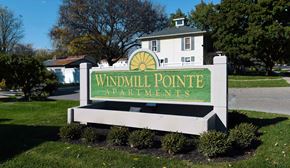Armada apartment for rent - A sign for Windmill Pointe Apartments in front of a building.
