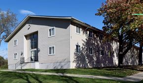 Armada apartment for rent - A grey building with a tree in front of it.