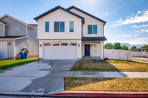 American Fork apartment for rent - A two-story house with a garage and a driveway.