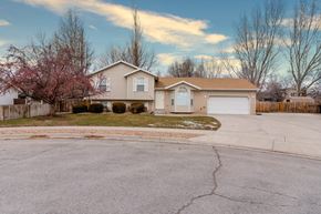 Lehi apartment for rent - a beige house on the corner of a street