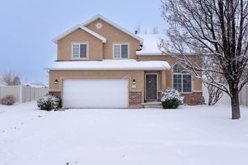 Spanish Fork apartment for rent - A house with a white garage door and a brown roof.