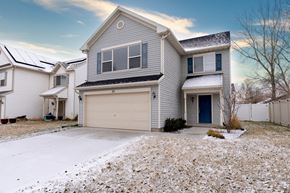 Saratoga Springs apartment for rent - a house with a garage door and a snow covered driveway