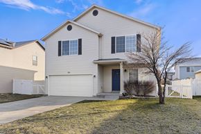 Spanish Fork apartment for rent - a white house with a yard and a white fence