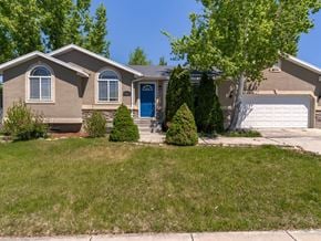 Syracuse apartment for rent - A house with a blue door and a tree in front.