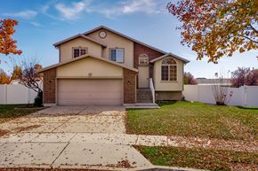 Clearfield apartment for rent - A house with a brown roof and a white garage door.