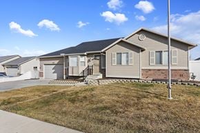 West Jordan apartment for rent - A house with a grey roof and a white garage door.