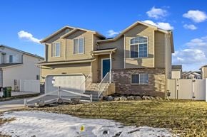 Syracuse apartment for rent - a tan and brown house with a snow covered yard