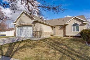 Layton apartment for rent - a beige house with a garage and a lawn