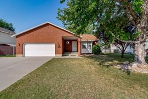 Clinton apartment for rent - the front of a brick house with a white garage door