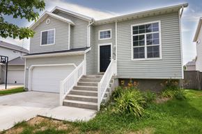 Eagle Mountain apartment for rent - a blue house with a porch and a white staircase