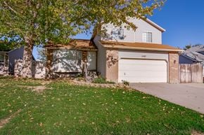 West Jordan apartment for rent - a house with a white garage door and a green lawn