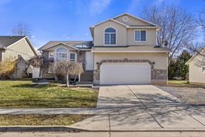 Layton apartment for rent - A house with a garage and a driveway in front.