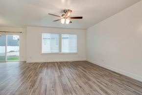 Saratoga Springs apartment for rent - A room with a ceiling fan and wooden flooring.