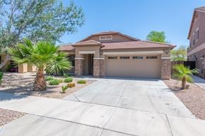 Queen Creek apartment for rent - A house with a driveway and a palm tree in front.