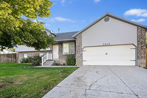 Lehi apartment for rent - a white and brick house with a white garage door