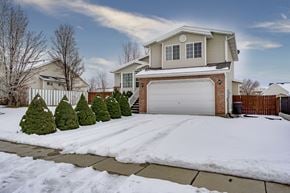 Clinton apartment for rent - a house with snow on the driveway and a garage door
