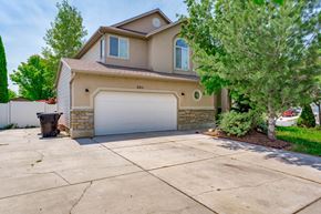 Clearfield apartment for rent - a beige house with a white garage door