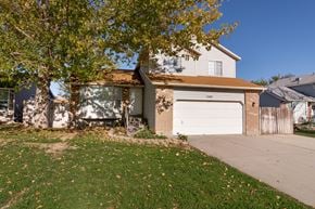 West Jordan apartment for rent - a house with a white garage door and a sidewalk
