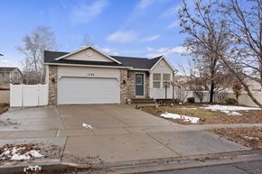 Layton apartment for rent - A house with a garage and a driveway in front.