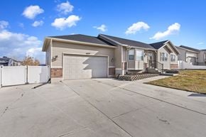 West Jordan apartment for rent - A house with a garage and a driveway in front.
