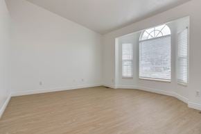 Lehi apartment for rent - A room with wooden flooring and a window with blinds.