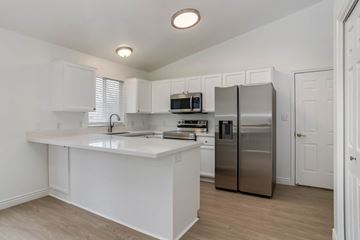Lehi apartment for rent - A kitchen with white cabinets and a white island.