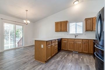 Clinton apartment for rent - A kitchen with wooden cabinets and a black refrigerator.